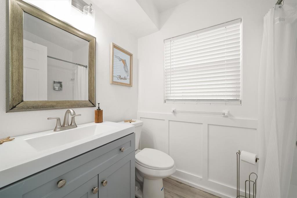 711 East Gulf Boulevard Indian Rocks Beach, FL 33785 - Photo 20 of 35 a bathroom with a sink toilet and mirror