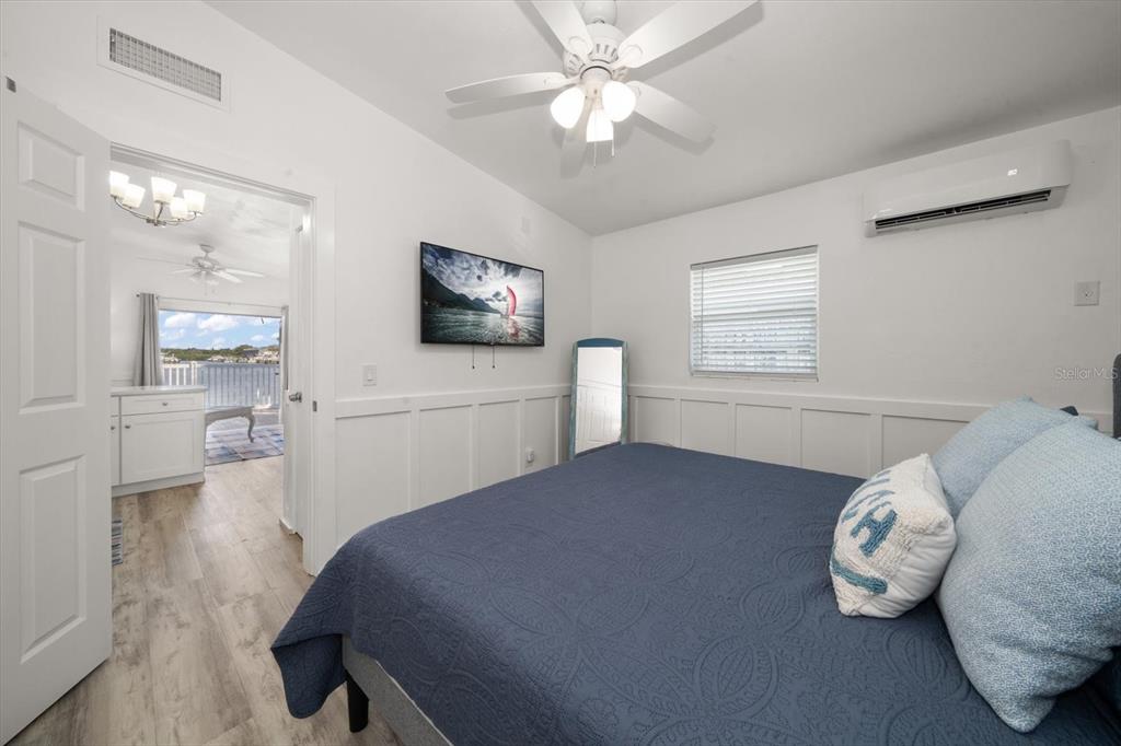711 East Gulf Boulevard Indian Rocks Beach, FL 33785 - Photo 24 of 35 a bedroom with a bed and a flat screen tv