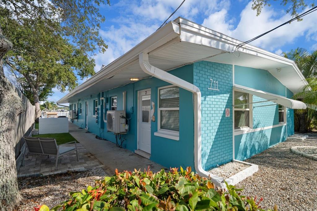 711 East Gulf Boulevard Indian Rocks Beach, FL 33785 - Photo 6 of 35 a front view of a house with garden