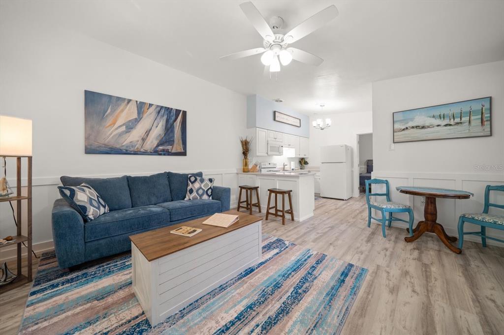 711 East Gulf Boulevard Indian Rocks Beach, FL 33785 - Photo 8 of 35 a living room with furniture and a chandelier