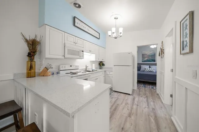 a kitchen with stainless steel appliances a refrigerator sink and cabinets