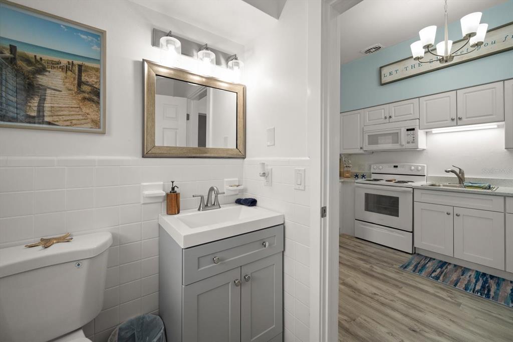 711 East Gulf Boulevard Indian Rocks Beach, FL 33785 - Photo 10 of 35 a kitchen with a sink cabinets and stainless steel appliances