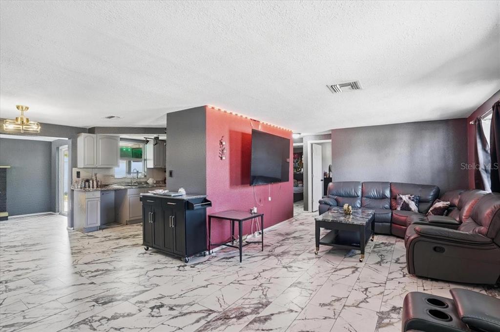 3208 Kilburn Road Holiday, FL 34691 - Photo 11 of 17 a living room with furniture and a flat screen tv