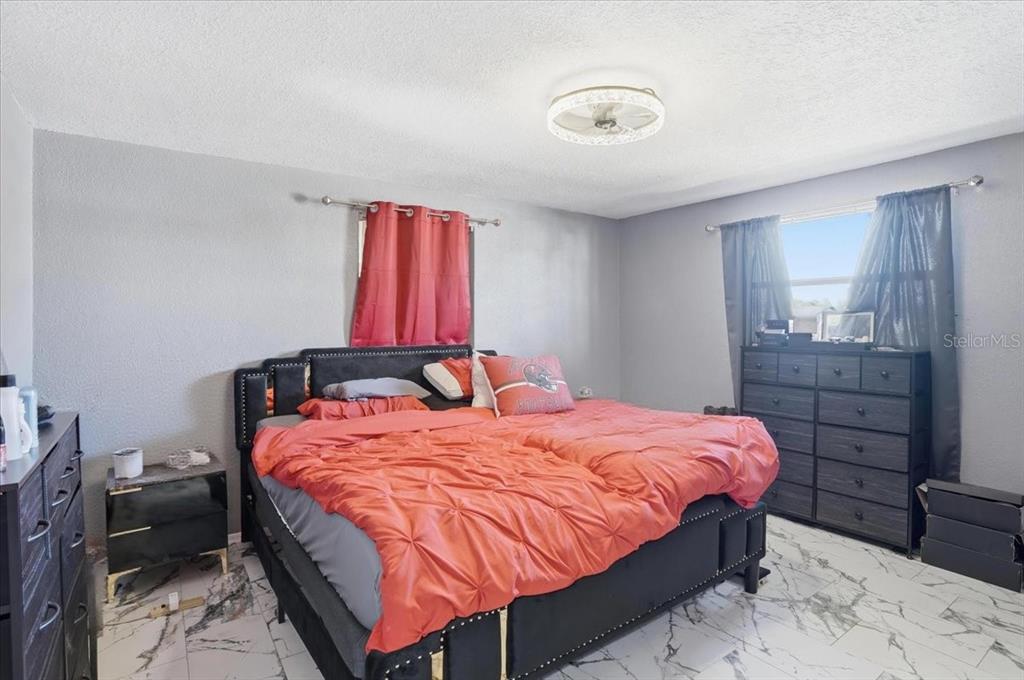 3208 Kilburn Road Holiday, FL 34691 - Photo 12 of 17 a bedroom with a bed and a dresser