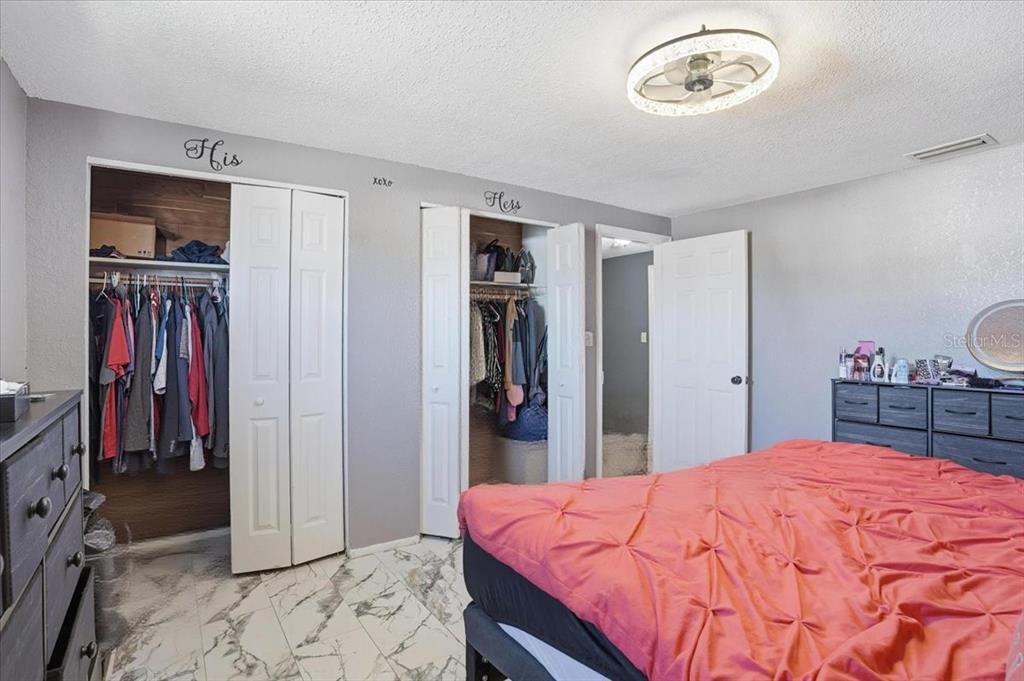 3208 Kilburn Road Holiday, FL 34691 - Photo 13 of 17 a bed room with a bed and a mirror