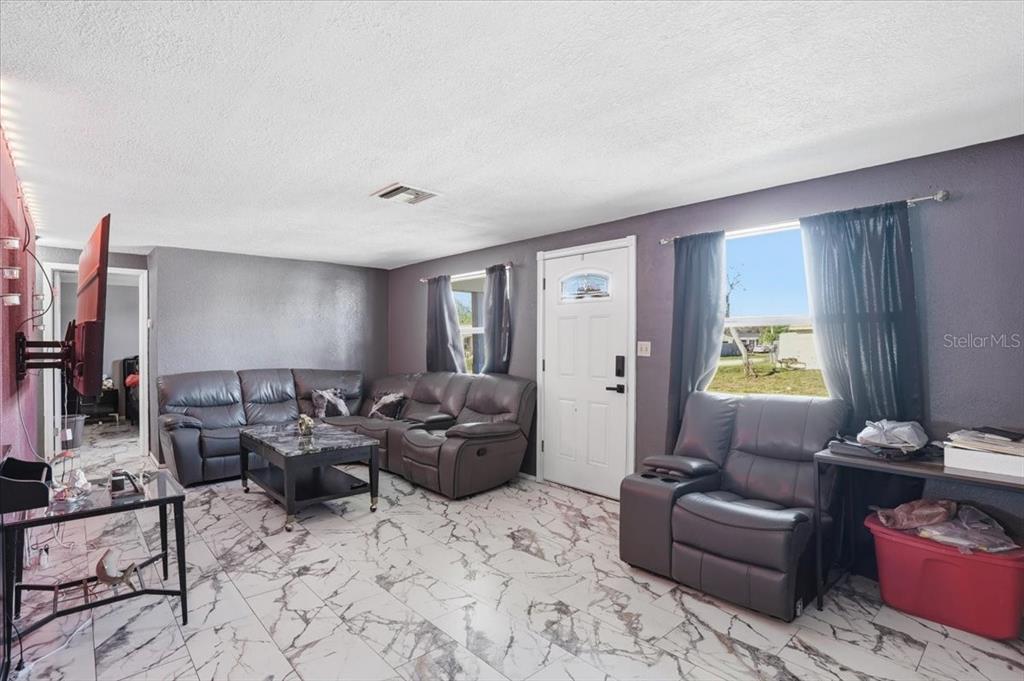 3208 Kilburn Road Holiday, FL 34691 - Photo 8 of 17 a living room with furniture and a window
