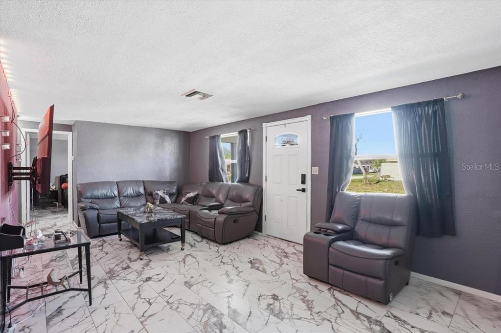 3208 Kilburn Road Holiday, FL 34691 - Photo 10 of 17 a living room with furniture and a window