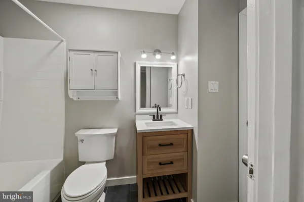 a bathroom with a toilet a sink and a mirror