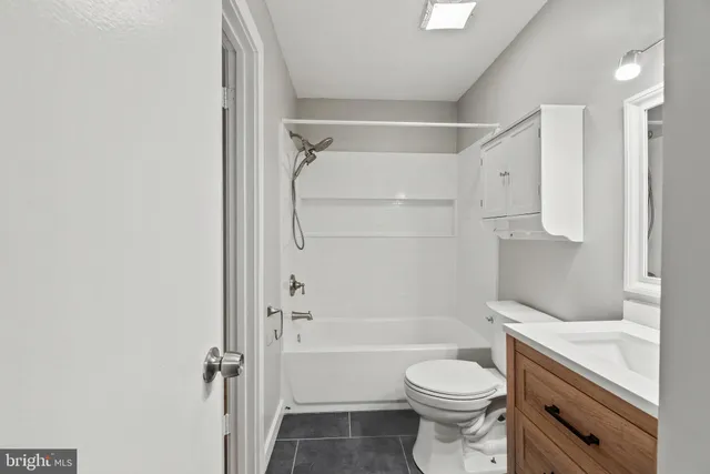a bathroom with a toilet sink and shower