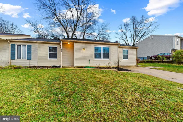a front view of house with yard and trees around