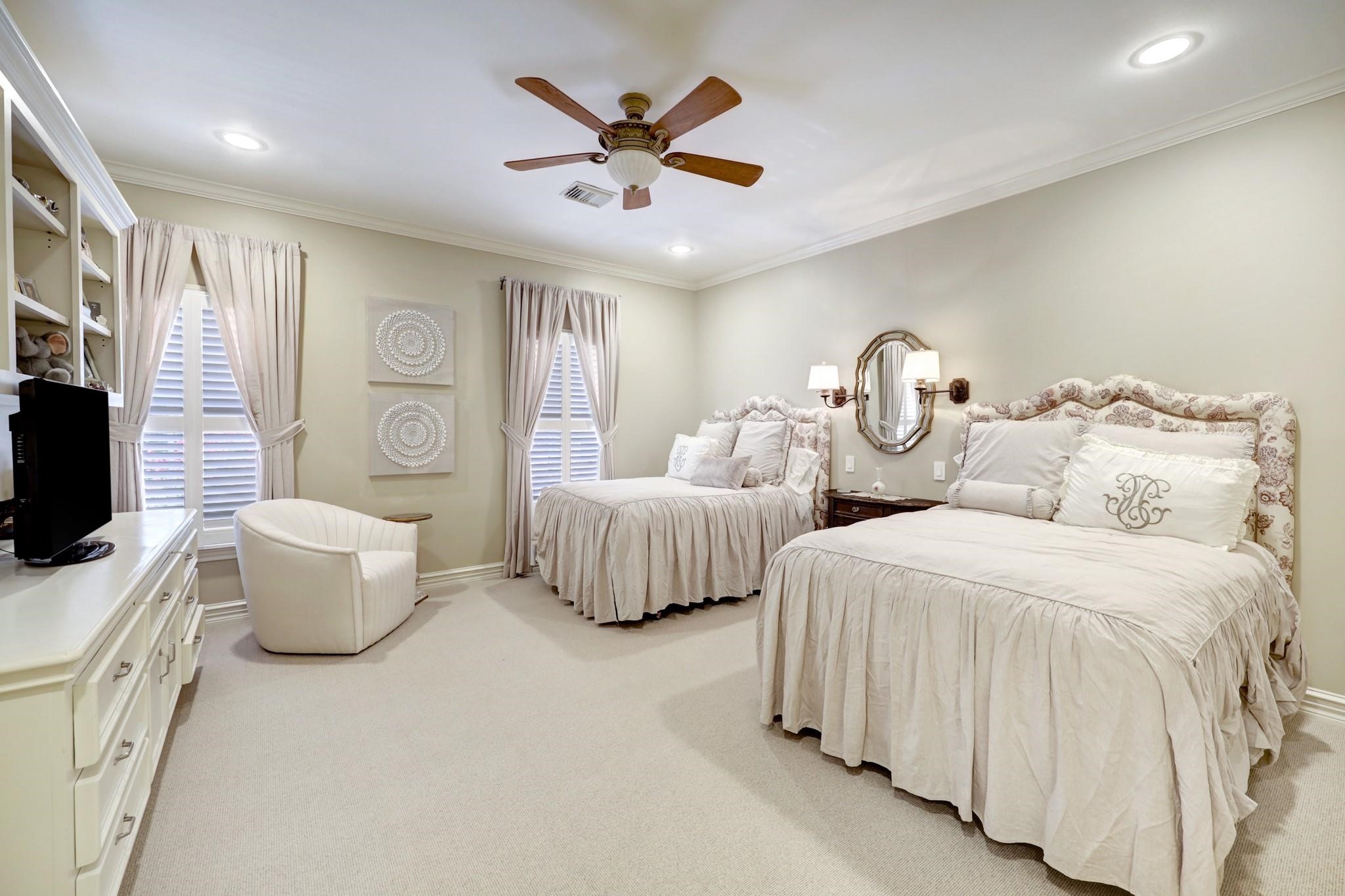 1229 Ripple Creek Drive Houston, TX 77057 - Photo 39 of 49 This photo showcases a compact, well-organized home office with ample cabinetry for storage, a built-in desk with a printer, and a comfortable chair, perfect for a productive workspace.