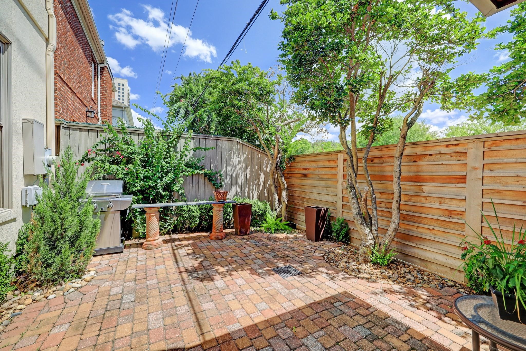 1229 Ripple Creek Drive Houston, TX 77057 - Photo 45 of 49 This photo shows a modern laundry room with a front-loading washer and dryer. The room features upper cabinets for storage and a shelf for additional space. The neutral color palette and clean design make it functional and efficient.