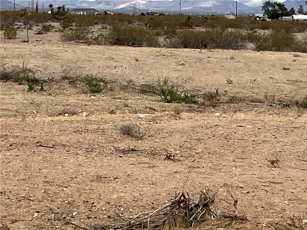 0 South Escuela (024) Road Golden Valley, AZ 86413 - Photo 2 of 6 View of lot with mountain backdrop with rural landscape