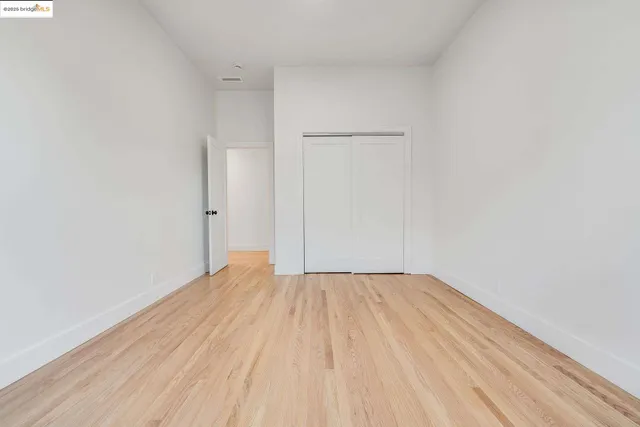 a view of wooden floor in a hall with a window