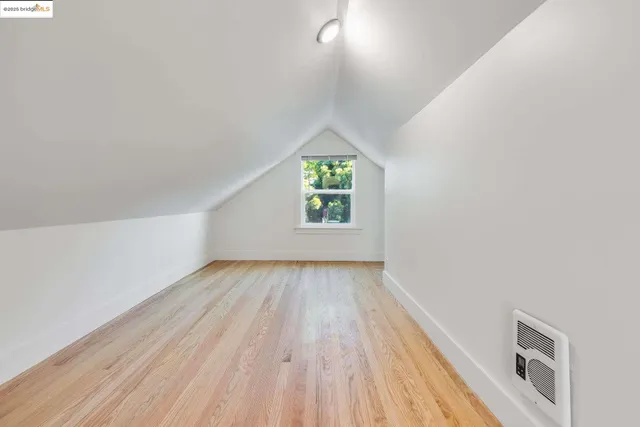 a view of a room with wooden floor and a ceiling fan