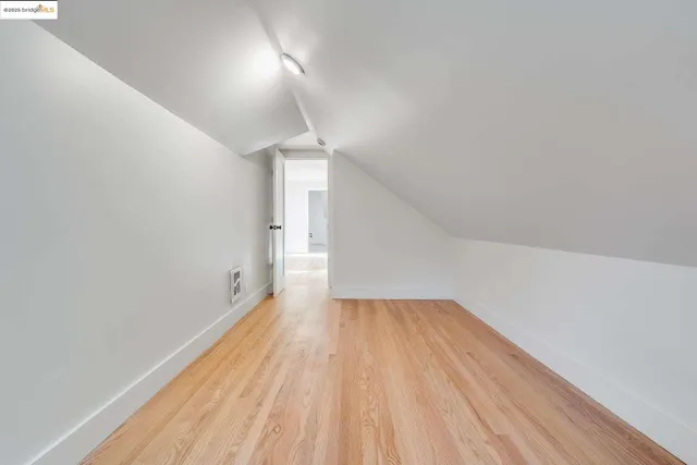 a view of a room with wooden floor and a window