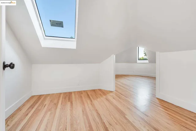 a view of a room with wooden floor and white walls