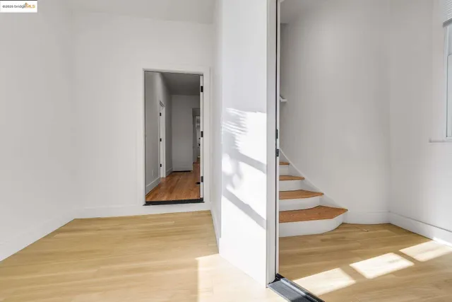 a view of empty room with wooden floor