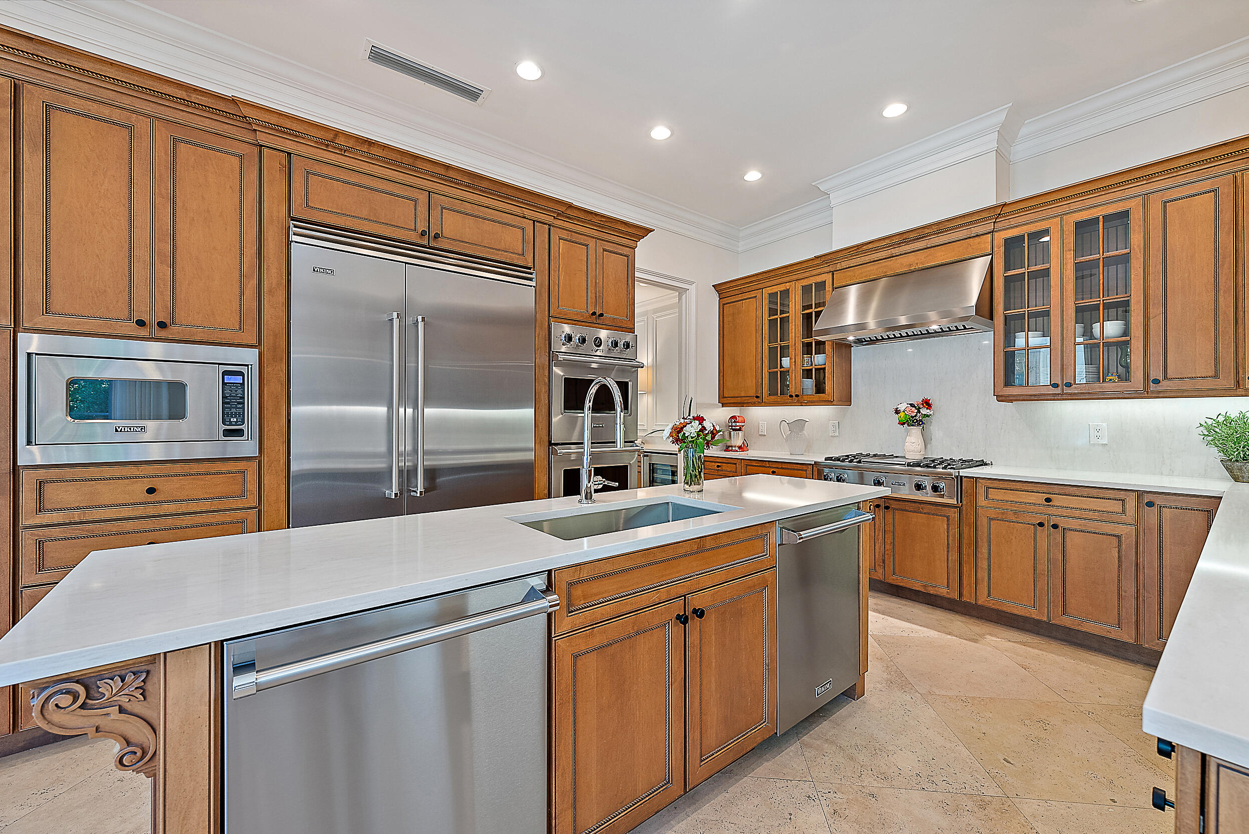 314 Chilean Avenue Palm Beach, FL 33480 - Photo 14 of 46 a kitchen with stainless steel appliances granite countertop a sink and dishwasher a refrigerator with wooden cabinets