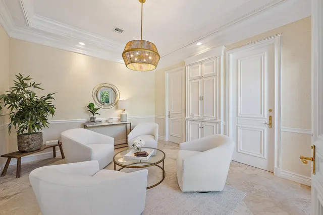 a living room with furniture a dining table and a chandelier