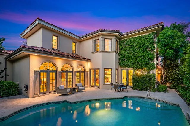 a front view of a house with patio yard and swimming pool