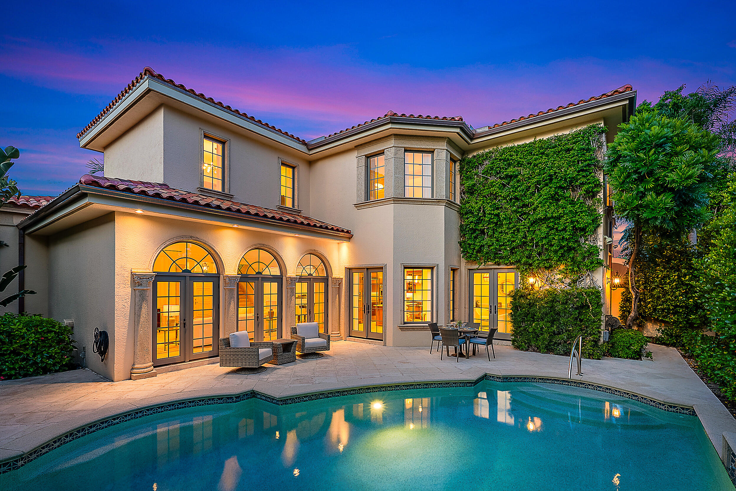 314 Chilean Avenue Palm Beach, FL 33480 - Photo 2 of 46 a front view of a house with patio yard and swimming pool