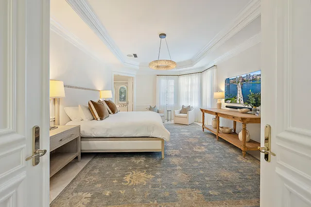 a spacious bedroom with a bed and a window