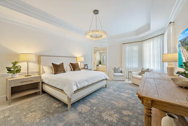 a bedroom with a bed and a chandelier