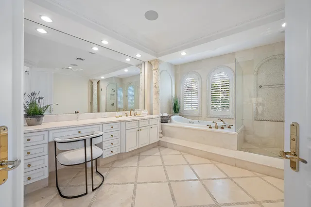 a spacious bathroom with a double vanity sink and a bathtub