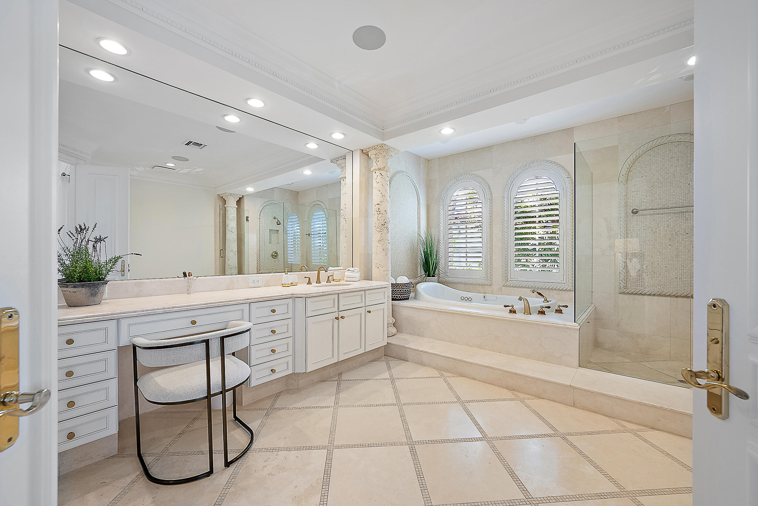 314 Chilean Avenue Palm Beach, FL 33480 - Photo 24 of 46 a spacious bathroom with a double vanity sink and a bathtub