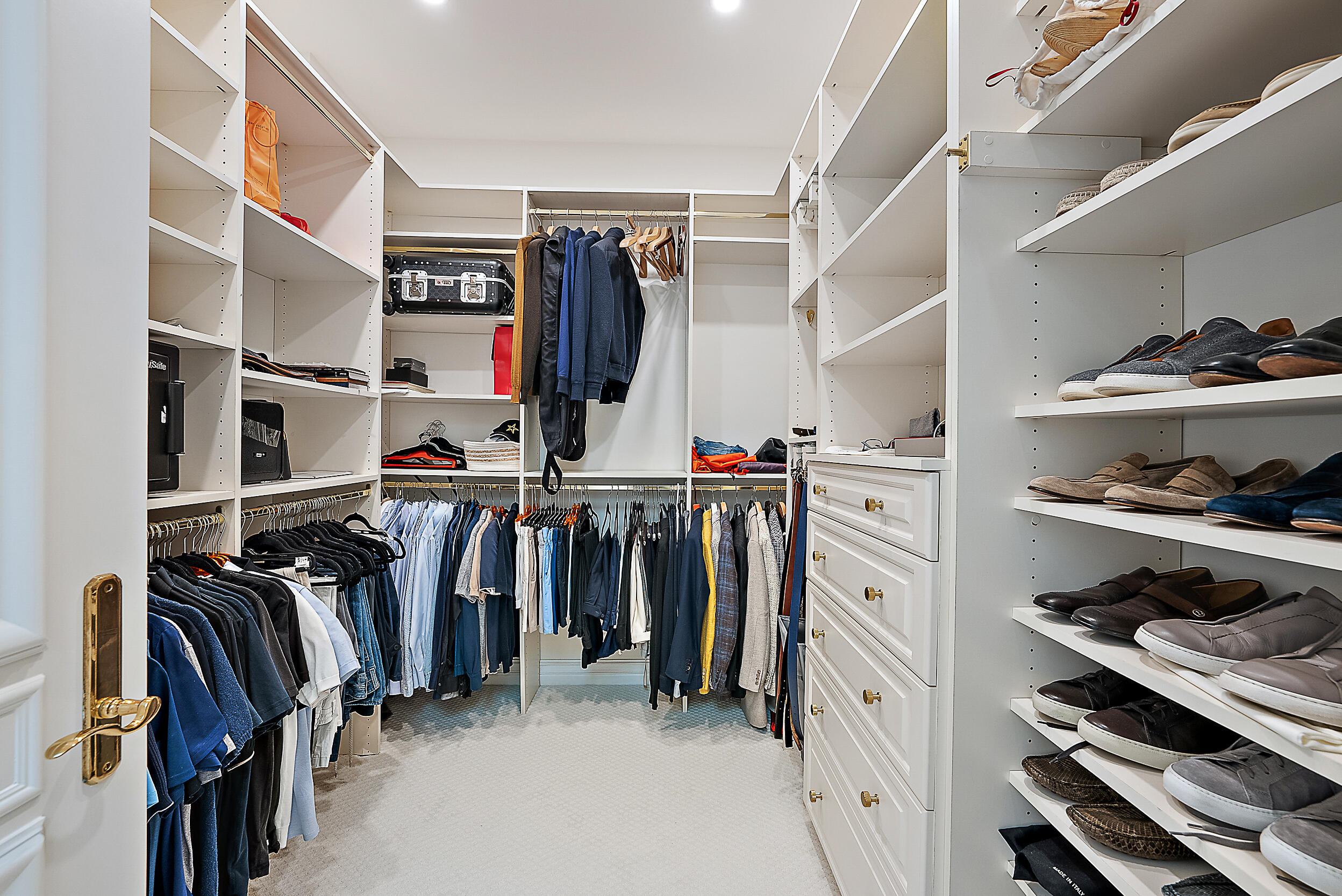 314 Chilean Avenue Palm Beach, FL 33480 - Photo 28 of 46 a view of walk in closet with clothes and shoes