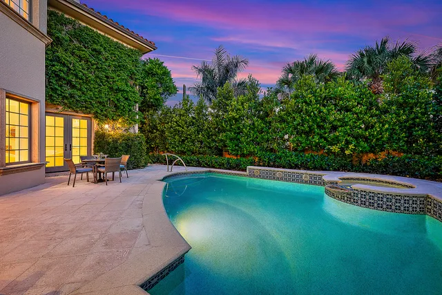 a swimming pool with outdoor seating and yard