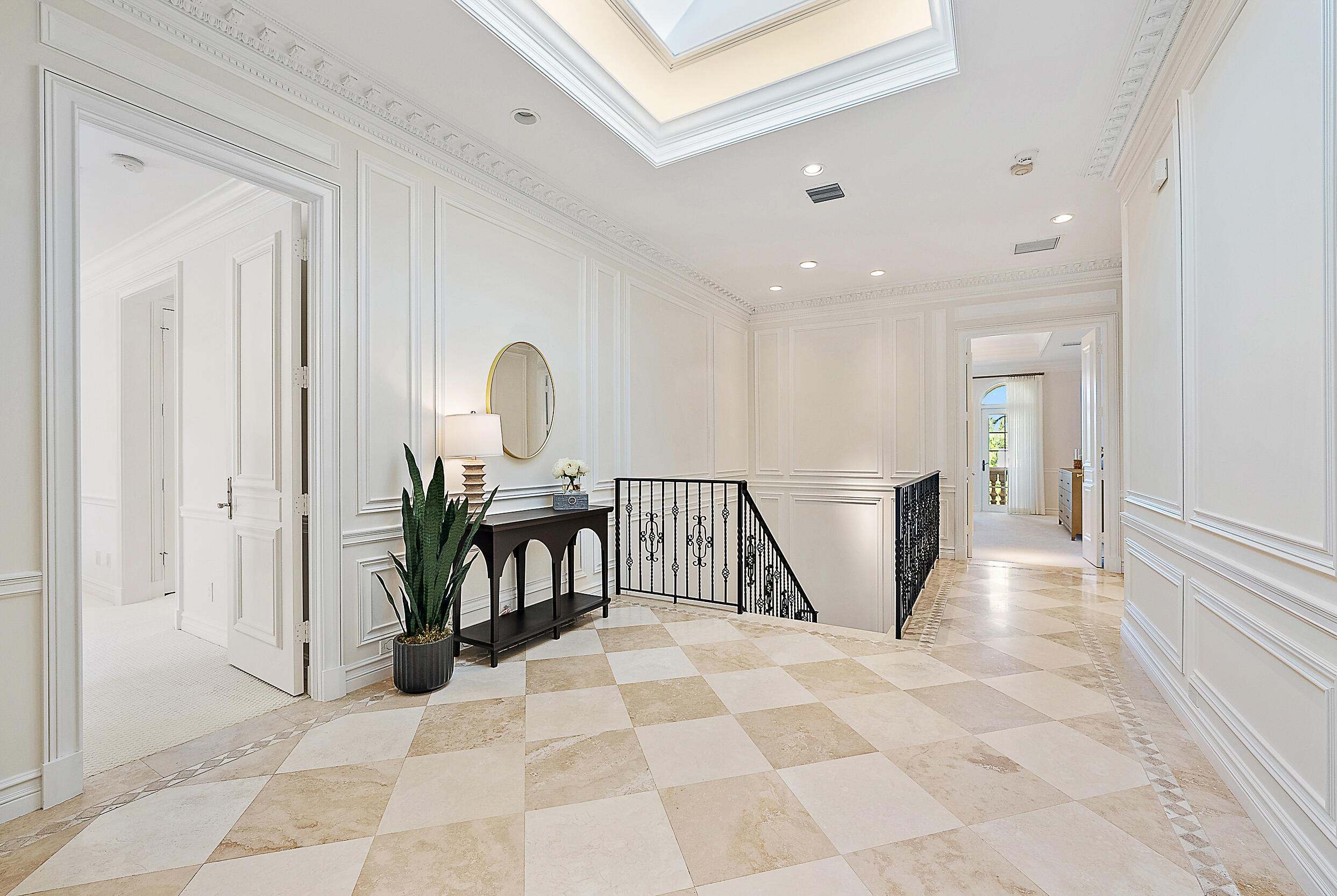 314 Chilean Avenue Palm Beach, FL 33480 - Photo 32 of 46 a view of a hallway with a couch and chandelier