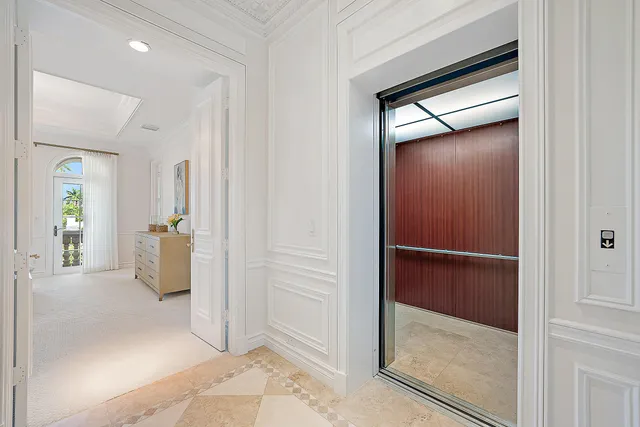 a view of a hallway with wooden shelves