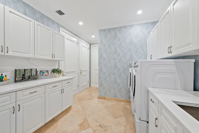 a kitchen with white cabinets and refrigerator