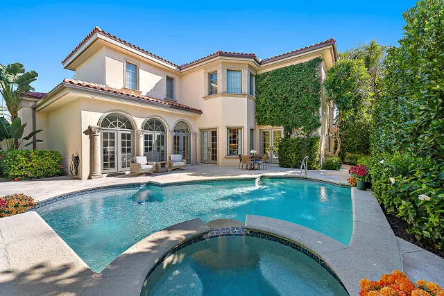 a front view of a house with swimming pool having outdoor seating