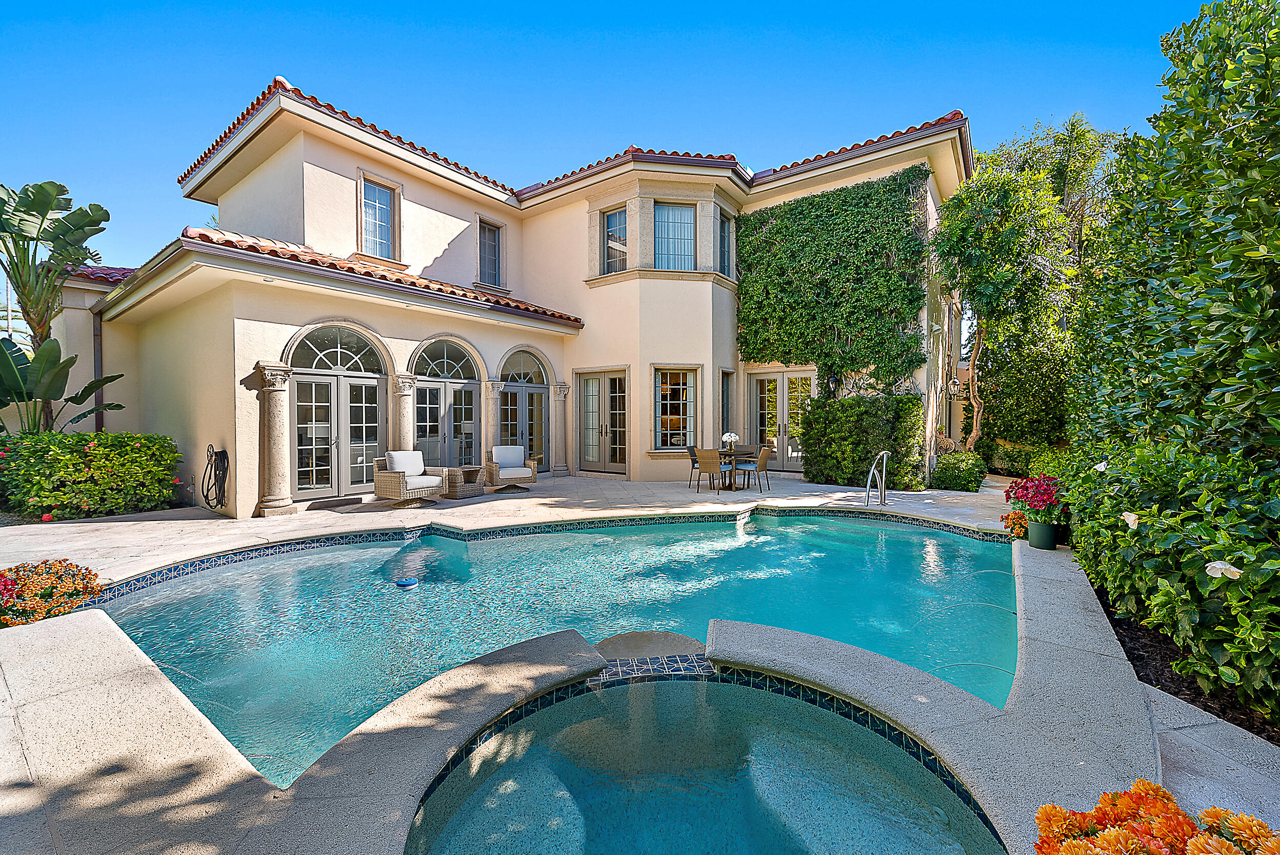 314 Chilean Avenue Palm Beach, FL 33480 - Photo 36 of 46 a front view of a house with swimming pool having outdoor seating