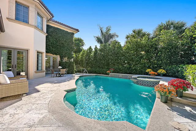 a swimming pool with outdoor seating and yard