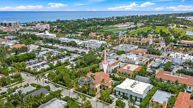an aerial view of residential houses with outdoor space and ocean view