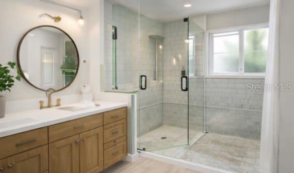 a bathroom with a double vanity sink mirror and shower