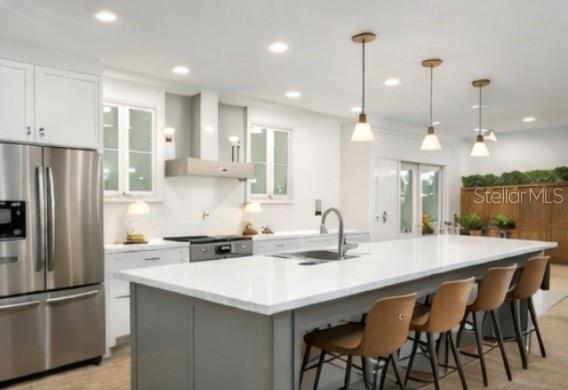 2352 Lorena Lane Clearwater, FL 33765 - Photo 4 of 5 a kitchen with stainless steel appliances granite countertop a sink a stove a refrigerator and a refrigerator