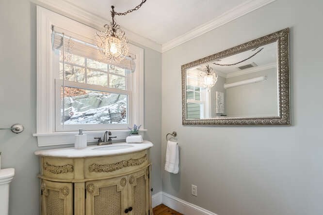 15 Maple Street Melrose, MA 02176 - Photo 17 of 38 a bathroom with a granite countertop sink mirror and a bathtub