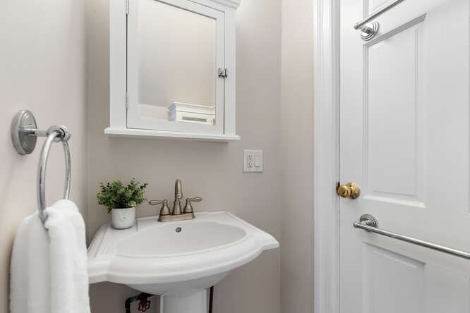 15 Maple Street Melrose, MA 02176 - Photo 23 of 38 a bathroom with a sink and mirror