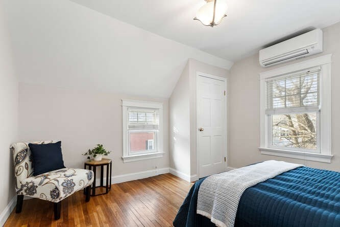 15 Maple Street Melrose, MA 02176 - Photo 27 of 38 a bedroom with a bed and wooden floor