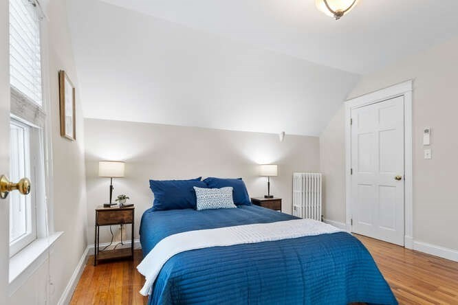 15 Maple Street Melrose, MA 02176 - Photo 28 of 38 a bedroom with a bed and wooden floor
