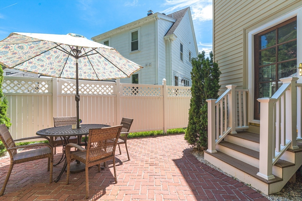 15 Maple Street Melrose, MA 02176 - Photo 33 of 38 a view of a patio with a table and chairs under an umbrella