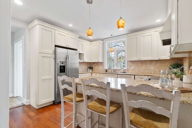 15 Maple Street Melrose, MA 02176 - Photo 5 of 38 a kitchen with stainless steel appliances granite countertop a refrigerator and a stove top oven