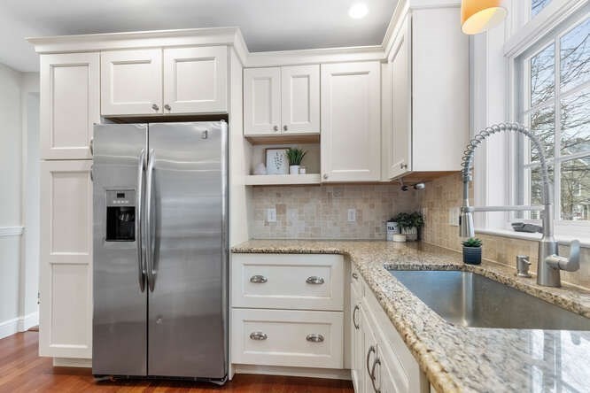15 Maple Street Melrose, MA 02176 - Photo 7 of 38 a kitchen with granite countertop a refrigerator and a sink