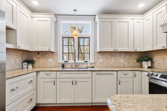 15 Maple Street Melrose, MA 02176 - Photo 8 of 38 a kitchen with granite countertop white cabinets and sink