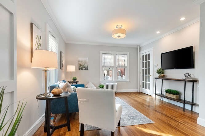 15 Maple Street Melrose, MA 02176 - Photo 10 of 38 a living room with fireplace furniture flat screen tv and wooden floor